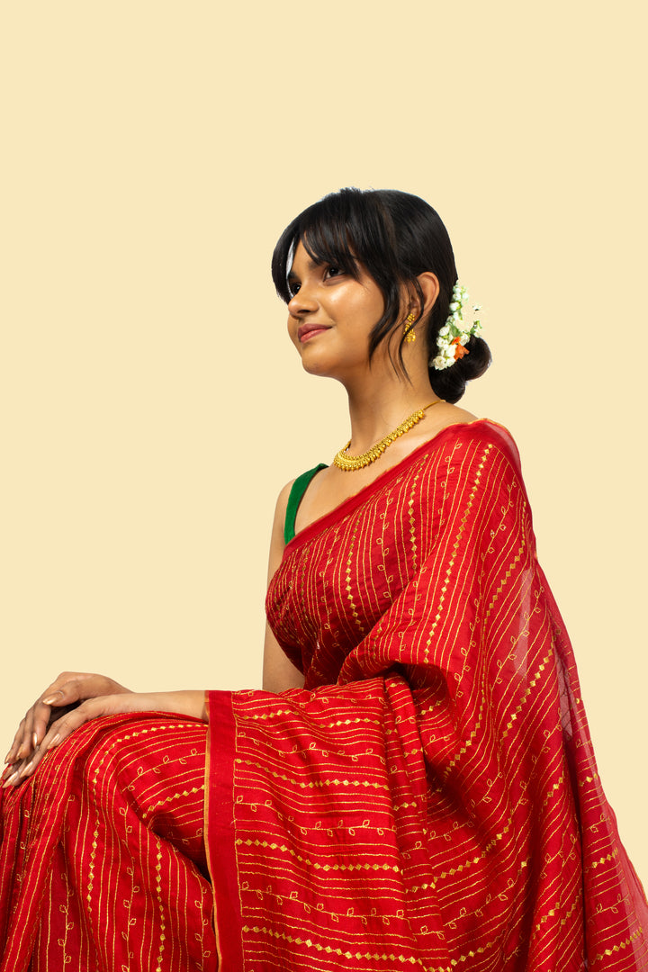 Close-up of stripe detail on red kasuti saree fabric
