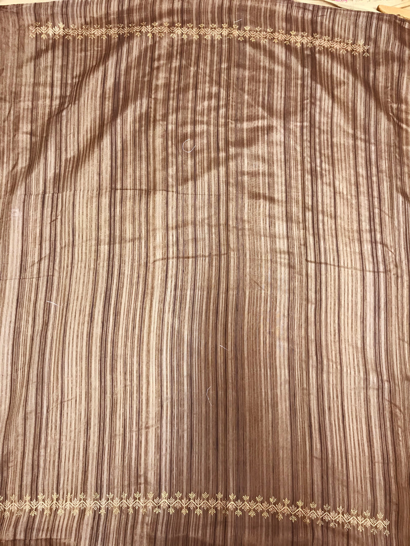 Draped shoulder view of brown kasuti striped saree