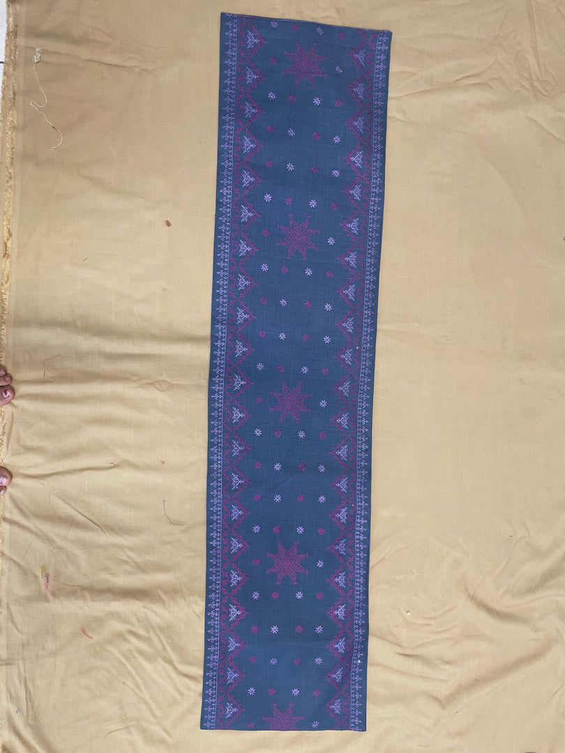 Folded navy blue tablerunner highlighting woven texture