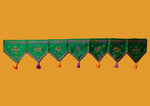Load image into Gallery viewer, Green kasuti toran shown in close-up with fabric stitchwork
