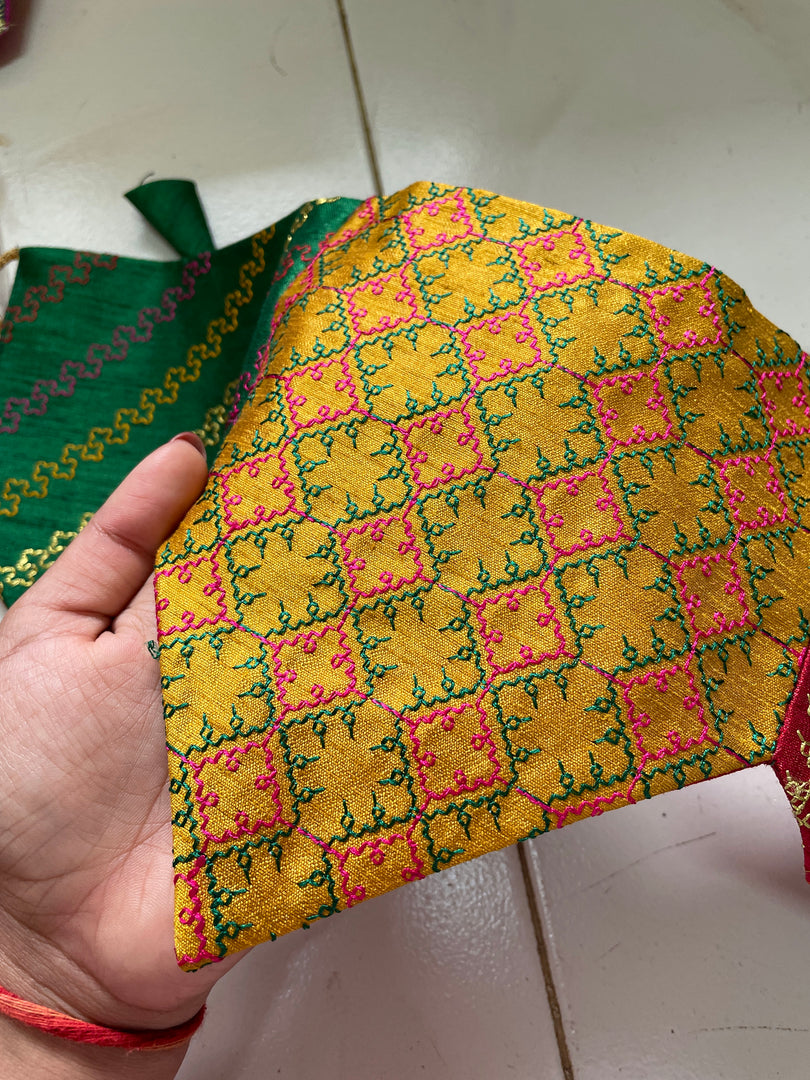 Close-up of parrot green ridhi siddhi toran embroidery and tassels