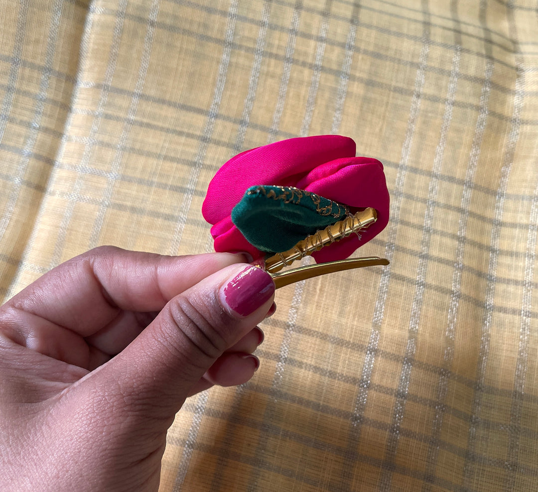 Close-up of embroidered red kasuti rose clip floral design