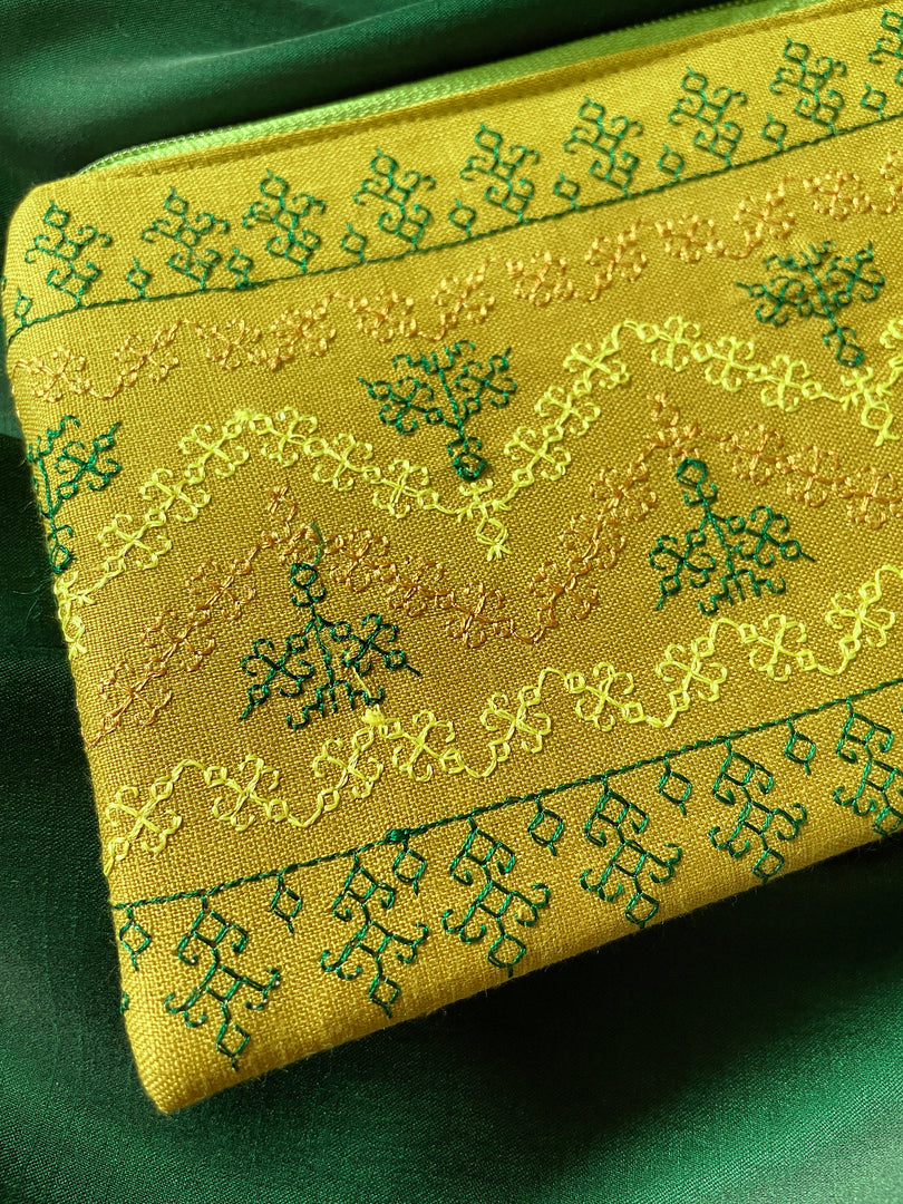 Side view of haldi maharani purse with embroidery and beaded tassels