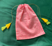 Blue embroidered potli bag featuring floral motifs and golden drawstring