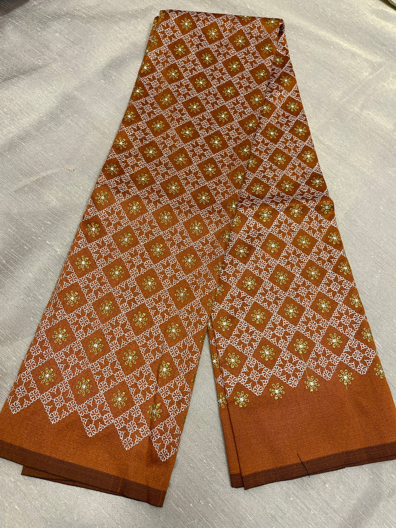 Traditional threadwork close-up on rust brown kasuti blouse