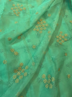 Load image into Gallery viewer, green flowers in the wind organza kasuti saree highlighting motifs
