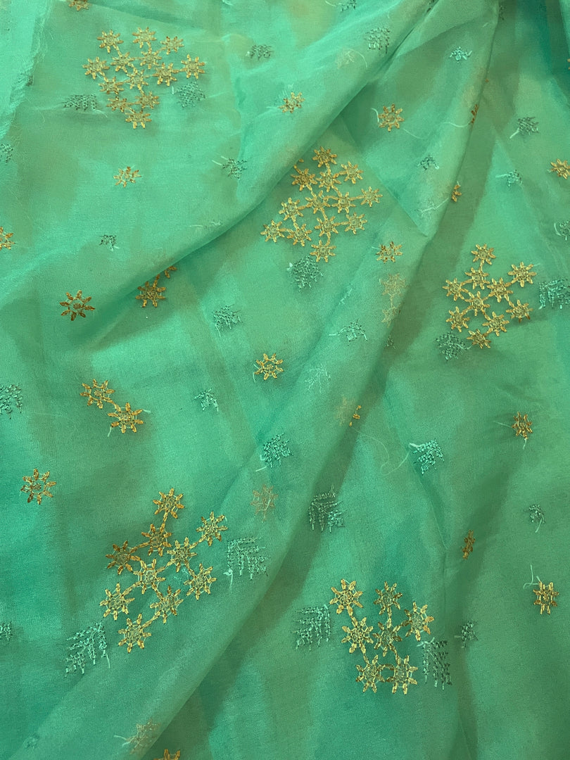 green flowers in the wind organza kasuti saree highlighting motifs