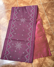 Grey table runner with embroidered border and textured fabric design