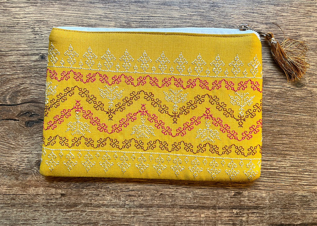 Mustard maharani purse close-up highlighting embroidered border details