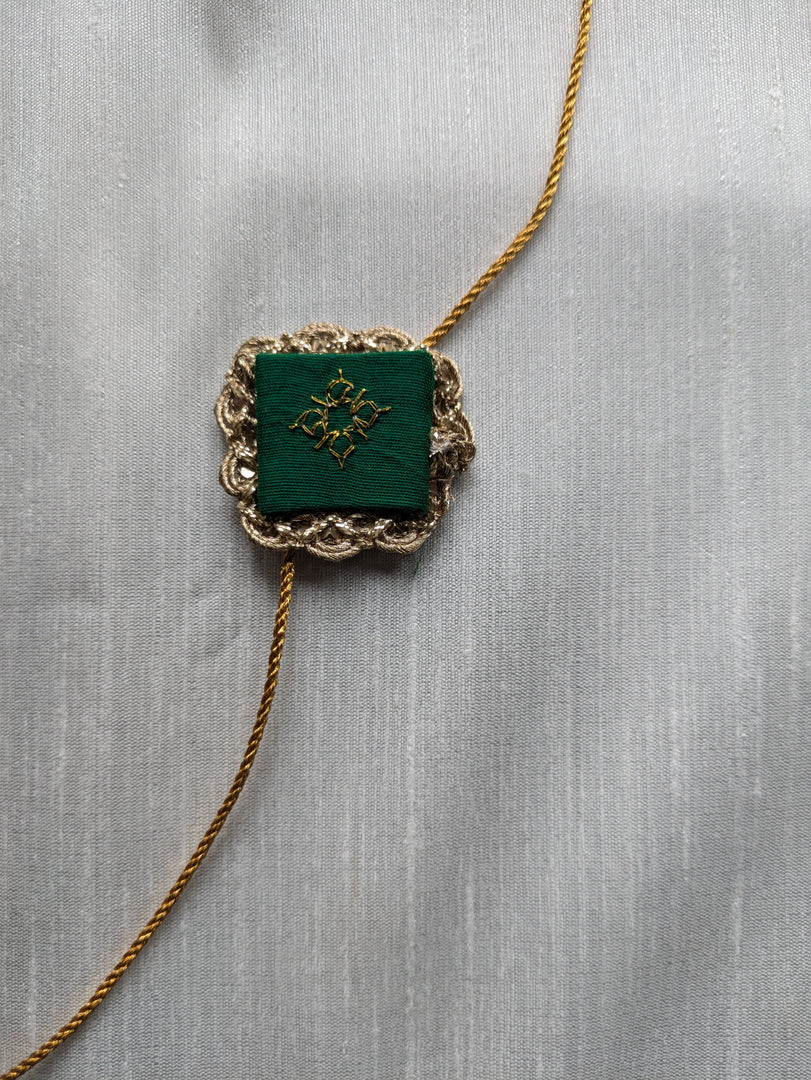 Bottle green kasuti rakhi with hand embroidery detail