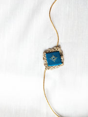 Blue kasuti rakhi with traditional embroidered threadwork