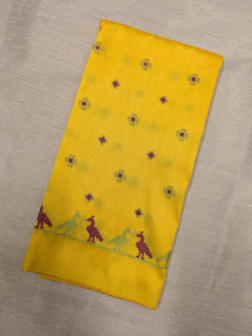 Yellow mayur blouse embroidery close-up on fabric
