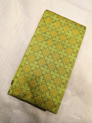 Embroidery close-up on green antara kasuti blouse with floral motifs