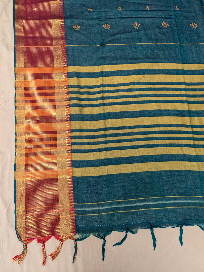 Folded section of green hasiru cotton saree showing hakki kasuti motifs