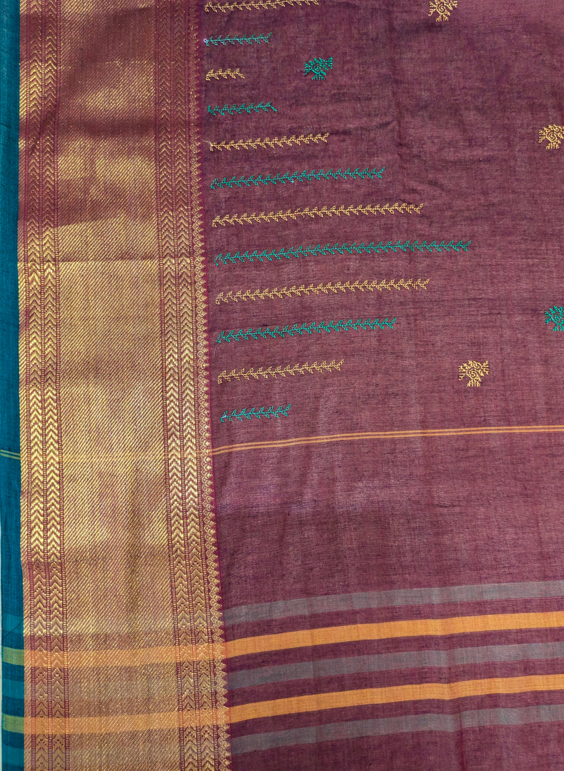 Folded view of kumkuma hakki kasuti cotton saree with fine bird embroidery