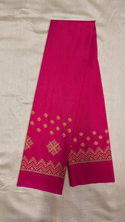 Close-up embroidery detail on rani pink kasuti blouse fabric