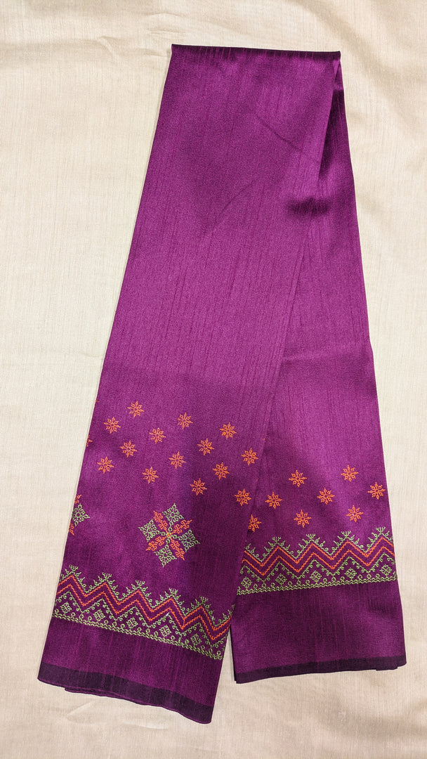 Embroidery close-up on purple kasuti blouse fabric