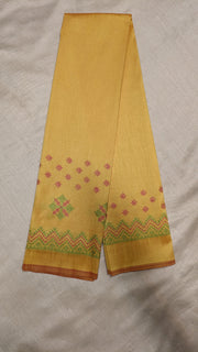 Angled side of yellow blouse with kasuti embroidered motifs