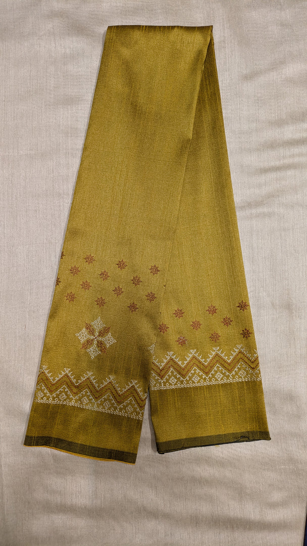 Angled view of mustard blouse featuring kasuti stitched motifs