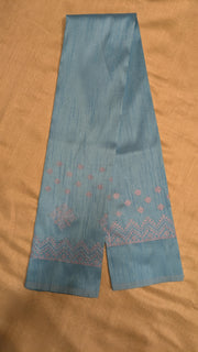 Sky blue kasuti blouse angled front view with stitched embroidery motifs