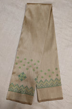 Load image into Gallery viewer, Angled side view of beige blouse showing kasuti embroidered motifs
