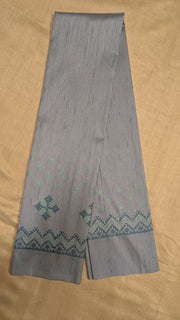 Side angled view of grey blouse highlighting kasuti stitchwork