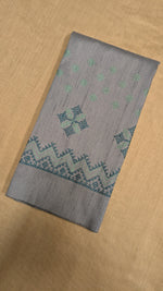 Load image into Gallery viewer, Close-up of embroidered motifs on grey kasuti blouse fabric
