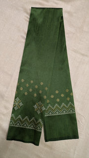 Angled side view of mehendi green blouse with kasuti motifs