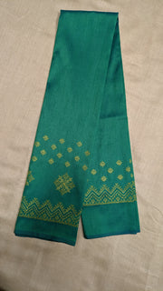 Angled view of emerald green blouse highlighting kasuti embroidery