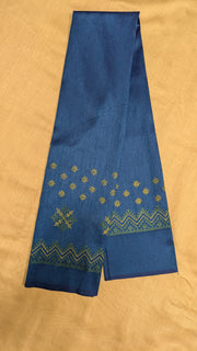Angled view of deep blue blouse showing kasuti threadwork on neckline
