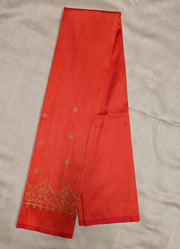 Side angled view of orange blouse with kasuti embroidery detail
