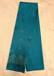 Close-up of kasuti threadwork on peacock blue blouse fabric