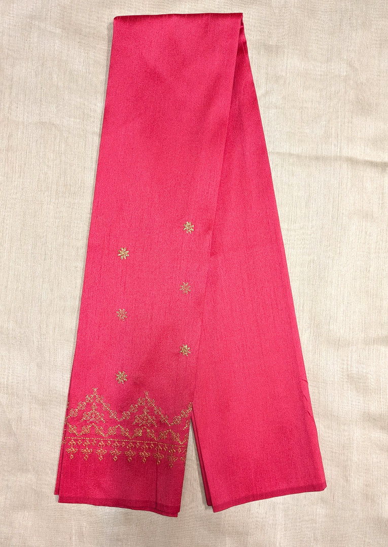 Angled side of red blouse with kasuti embroidery around neckline