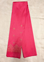 Angled side of red blouse with kasuti embroidery around neckline