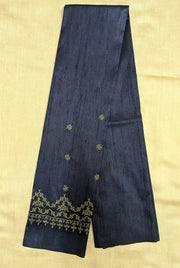 Detailed embroidery close-up of navy blue kasuti blouse fabric