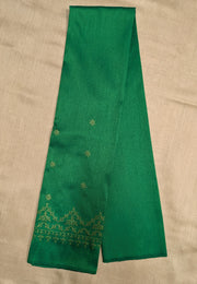 Angled side view of emerald green kasuti embroidered blouse
