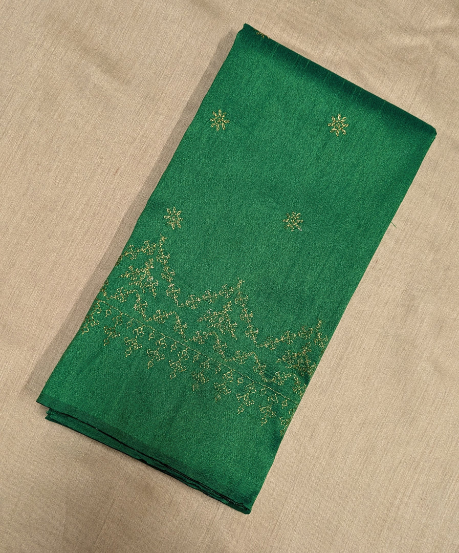 Close-up embroidery patterns on emerald green kasuti blouse fabric