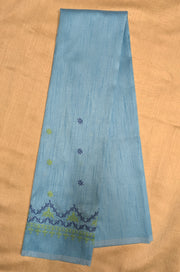 Angled view of sky blue blouse showing kasuti neckline work
