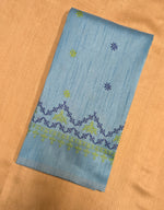 Load image into Gallery viewer, Close-up embroidery detail on sky blue kasuti blouse fabric

