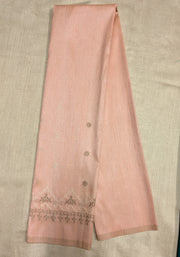 Angled view of peach kasuti blouse showing embroidered motifs on fabric