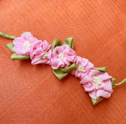 Baby pink handcrafted fabric gajra hairtie showing fabric floral detail