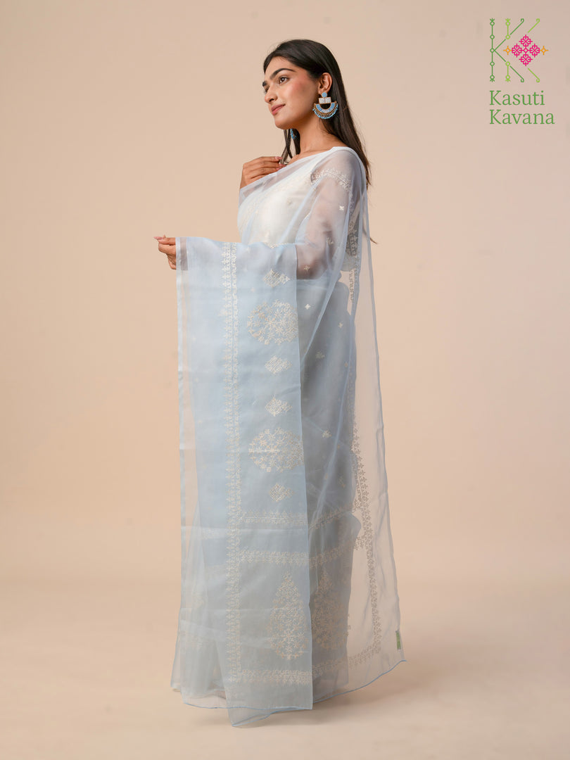 Cornflower blue organza kasuti saree showcasing delicate petal embroidery