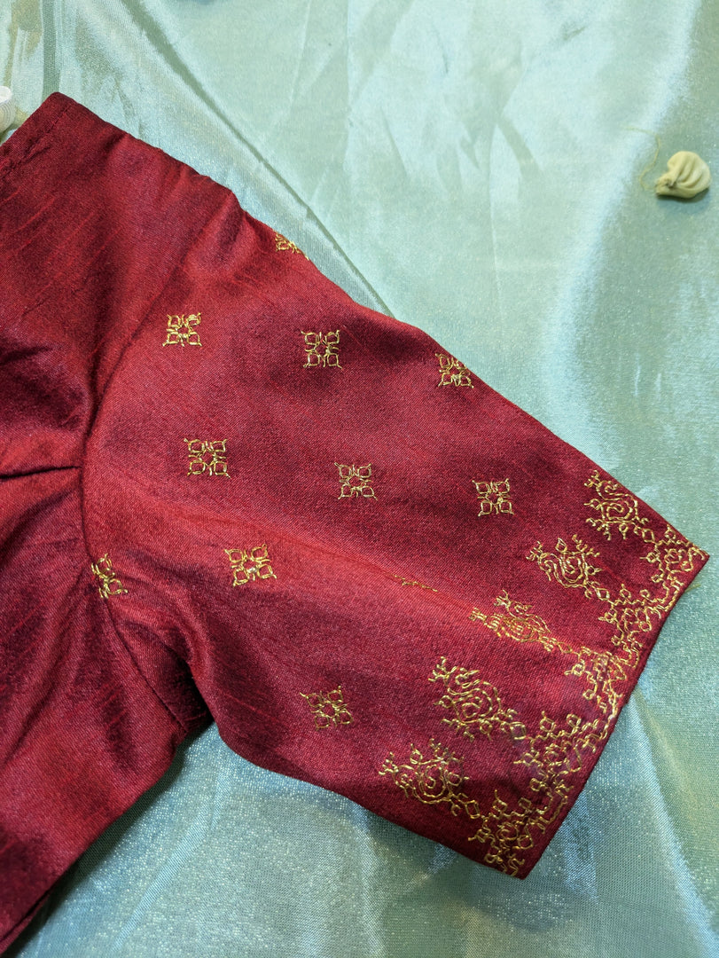 sleeve embroidery detail of maroon peacock kasuti stitched blouse