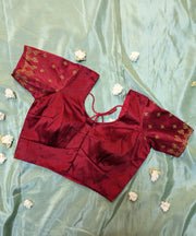 side view of maroon kasuti stitched blouse with embroidered peacock motifs