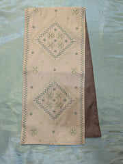beige hampi table runner with woven surface and simple stitched edges