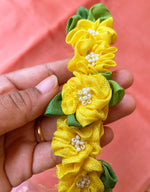 Load image into Gallery viewer, Lemon yellow handcrafted fabric gajra hairtie close-up showing fabric flowers
