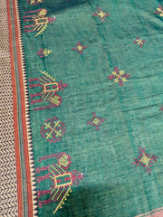 Close-up of green cotton saree showing aane kasuti embroidered details